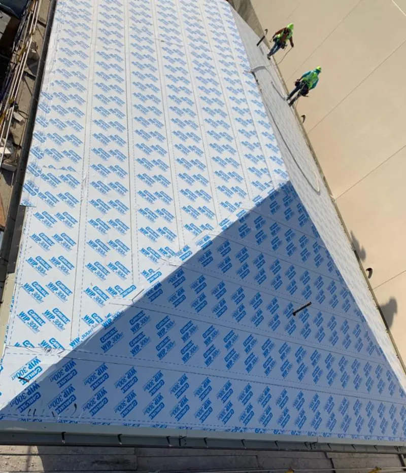 Professional roofers installing underlayment on a metal roof in Fuller Heights